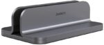 Spacegrey aluminum vertical laptop stand holding a MacBook Pro, showcasing its sleek design and desktop organization.