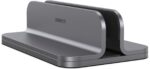 Spacegrey aluminum vertical laptop stand holding a MacBook Pro, showcasing its sleek design and desktop organization.