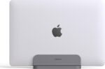 Spacegrey aluminum vertical laptop stand holding a MacBook Pro, showcasing its sleek design and desktop organization.