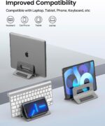 A space gray SODI vertical laptop stand holding a MacBook in an upright position on a clean desk.