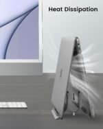 A space gray SODI vertical laptop stand holding a MacBook in an upright position on a clean desk.