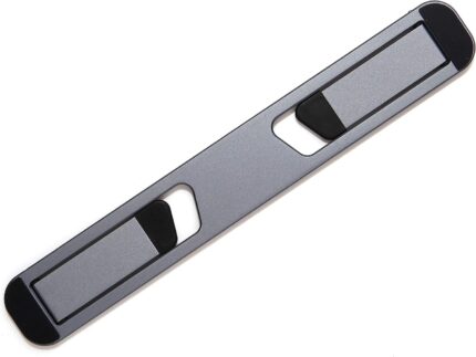 Space Grey Triyards self-adhesive foldable laptop stand attached to the underside of a laptop, elevating it.